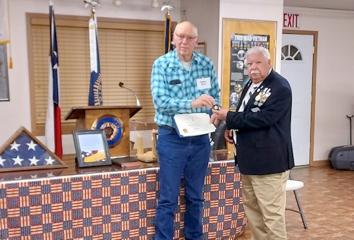 Changing of the Guards Clarence Burns receives a certificate and pin for his service as President of Ark-La-Tex Chapter #69, Sons of American Revolution from the new President, Larry Joe Reynolds