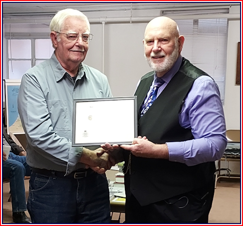 E. V. Wilson is presented a Certificate of Appreciation for his service in the United States Army by Secretary Rodney Love.