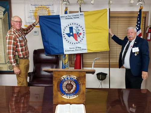 President Burns helps show the New Chapter Flag that was donated by Vice President Joe Reynolds.