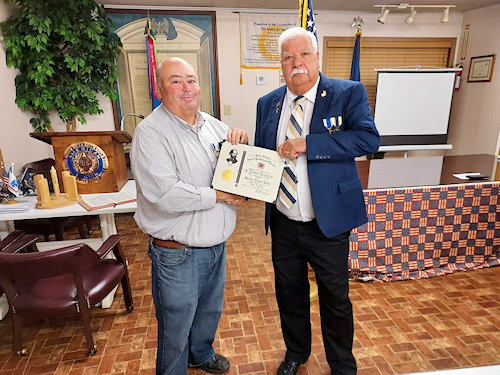 Vice-President Larry Joe Reynolds presents Chaplain Shawn Tulley with the Silver Cross with a Star from Sons of Confederate Veterans for a job well done.